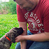 Dan scritching a young mastiff puppy